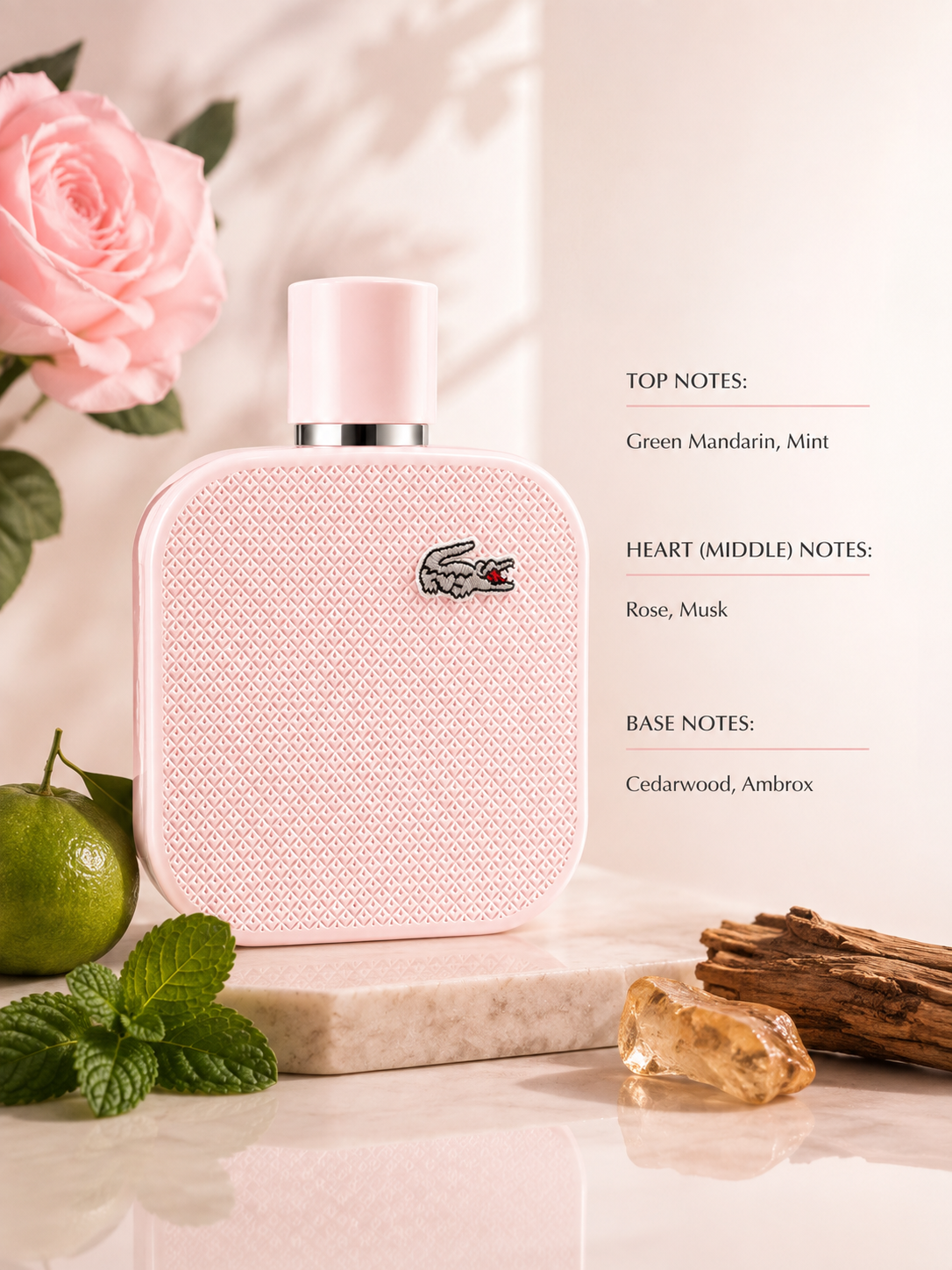 Lacoste L.12.12 Rose Eau de Parfum displayed with green mandarin, mint, rose and cedarwood elements, highlighting its fresh, floral, musky and woody fragrance character.