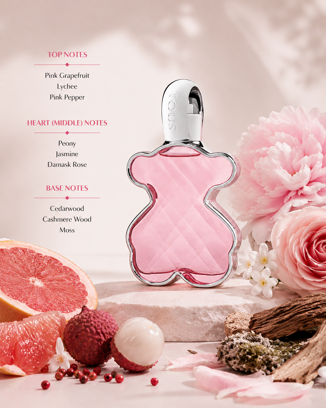 Tous Touch Eau de Toilette displayed with grapefruit, lychee, peony, rose, cedarwood, and cashmere wood accents. Notes shown: Top – pink grapefruit, lychee, pink pepper; Heart – peony, jasmine, Damask rose; Base – cedarwood, cashmere wood, and moss. Fresh floral-fruity presentation with a soft, romantic aesthetic.