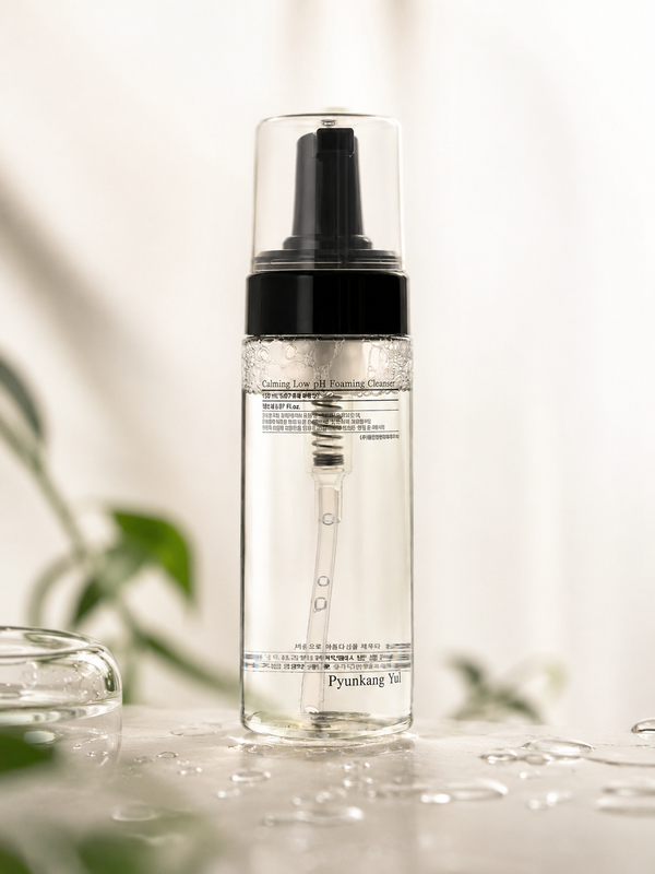Pyunkang Yul Calming Low pH Foaming Cleanser in a minimal watery skincare setting with green leaves