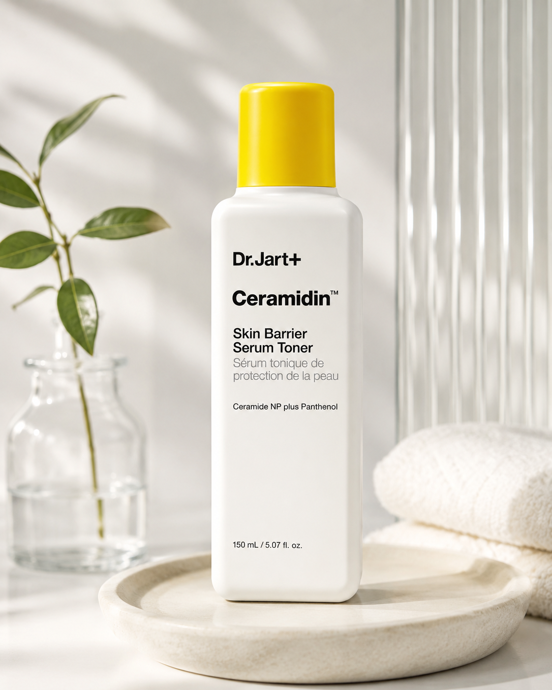 Dr.Jart+ Ceramidin Skin Barrier Serum Toner elegantly displayed on a minimalist ceramic tray beside soft white towels, a glass bottle with fresh greenery and warm natural light, creating a clean spa-inspired setting that highlights intensive hydration, skin barrier repair and everyday Korean skincare luxury.