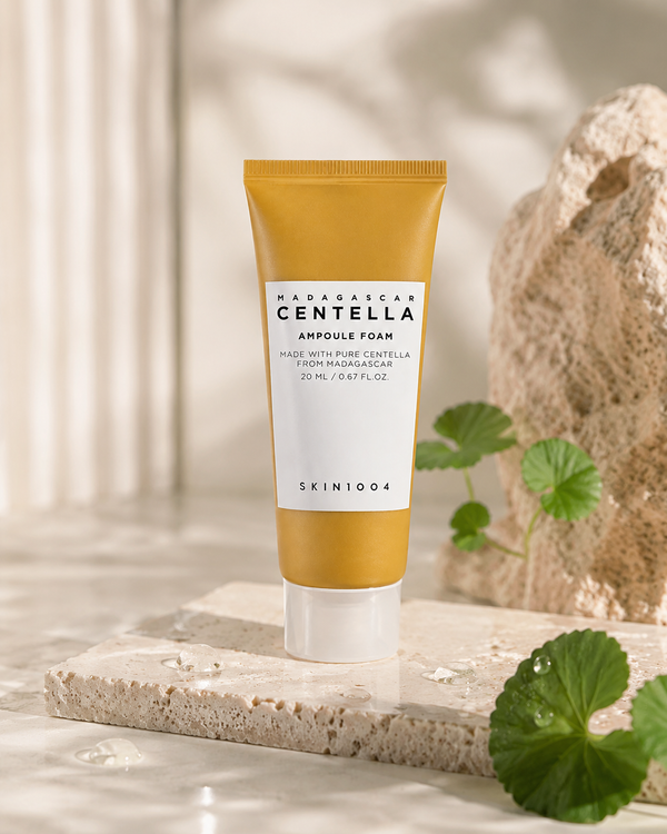 SKIN1004 Madagascar Centella Ampoule Foam displayed on stone with fresh green centella leaves